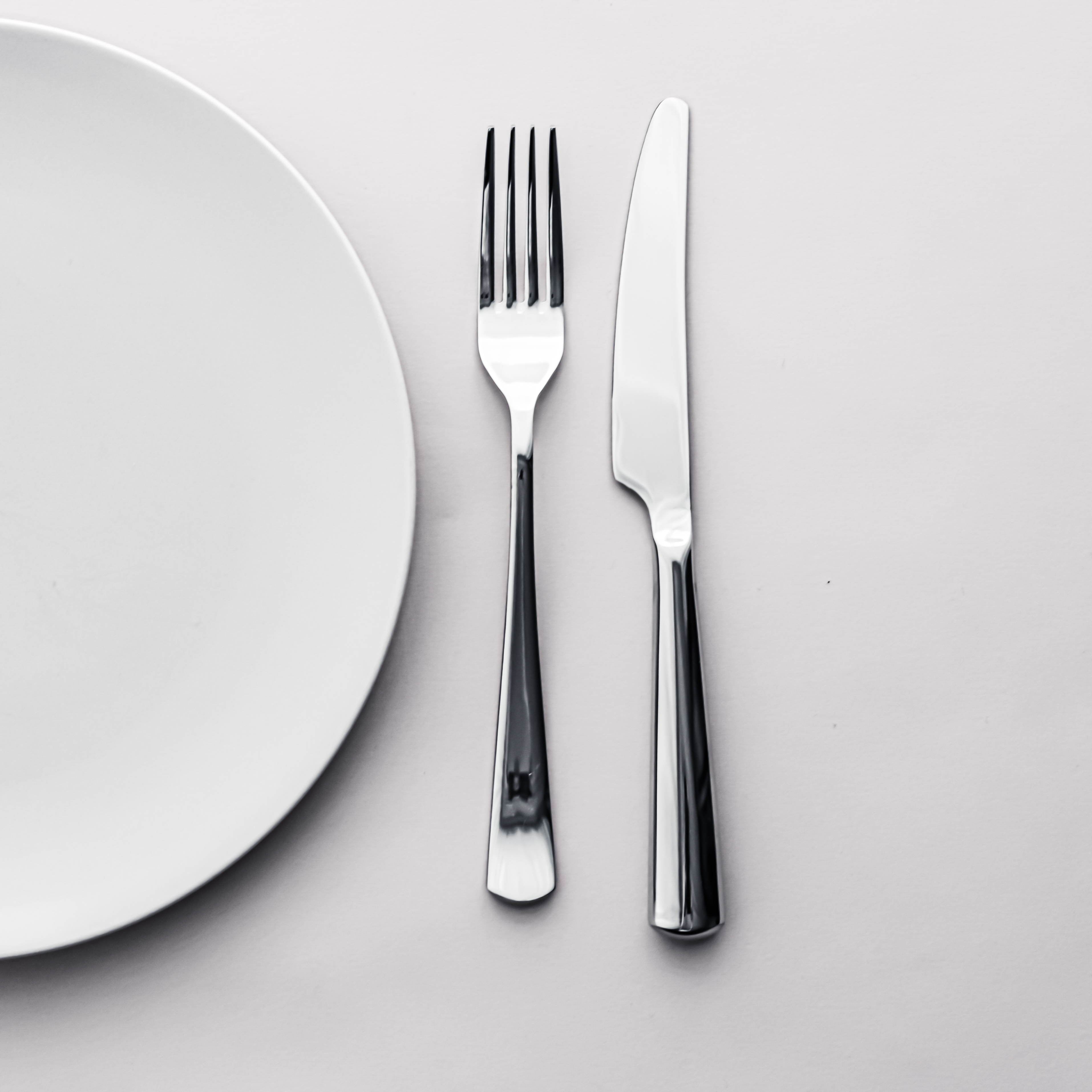 Empty Plate And Cutlery As Mockup Set On White Background, Top Tableware For Chef Table Decor And Menu Branding